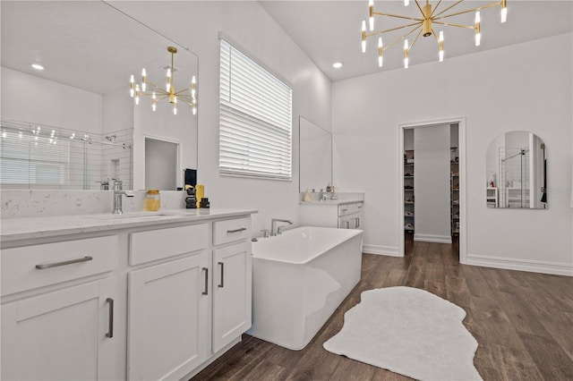 22034 Storybook Cabin Way, Land O Lakes, FL 34637 - full bath featuring a chandelier, a shower stall, vanity, wood finished floors, and recessed lighting