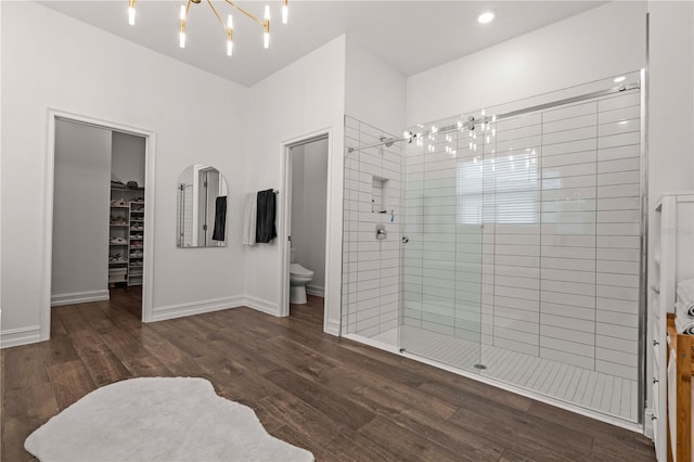 22034 Storybook Cabin Way, Land O Lakes, FL 34637 - full bathroom featuring a chandelier, a stall shower, a spacious closet, wood finished floors, and recessed lighting