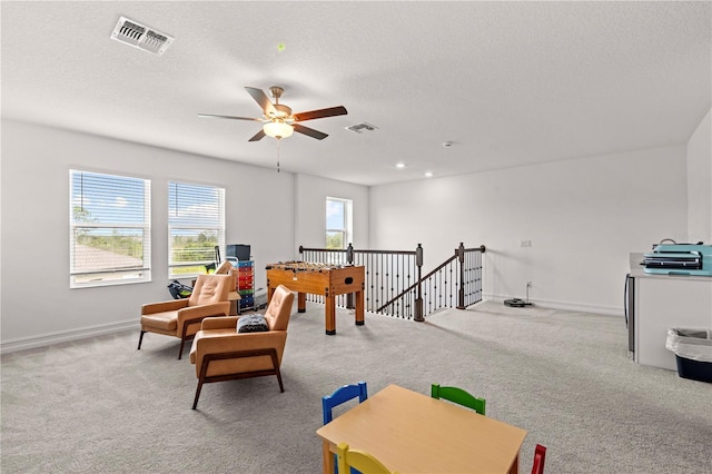 22034 Storybook Cabin Way, Land O Lakes, FL 34637 - playroom with carpet flooring, a ceiling fan, and a textured ceiling