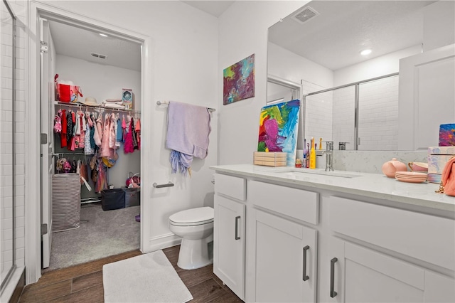 22034 Storybook Cabin Way, Land O Lakes, FL 34637 - full bathroom featuring wood finished floors, a spacious closet, a stall shower, vanity, and recessed lighting