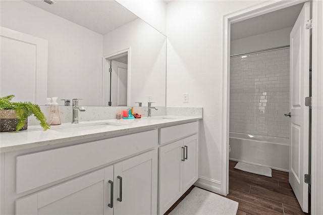 22034 Storybook Cabin Way, Land O Lakes, FL 34637 - full bathroom with double vanity, wood finished floors, and washtub / shower combination