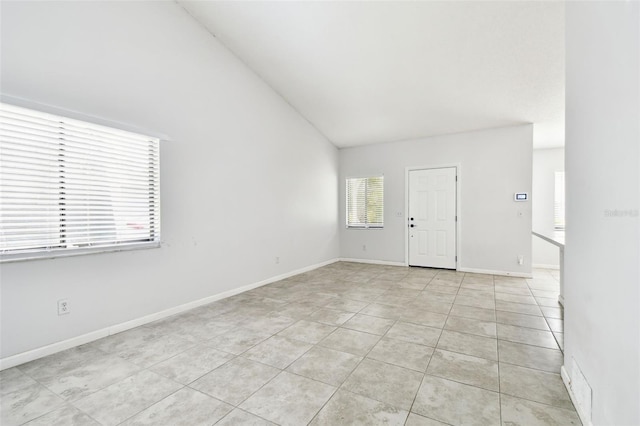12315 Hidden Brook Dr, Tampa, FL 33624 - empty room featuring light tile patterned floors and lofted ceiling