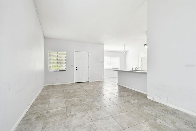 12315 Hidden Brook Dr, Tampa, FL 33624 - unfurnished room featuring light tile patterned flooring and baseboards
