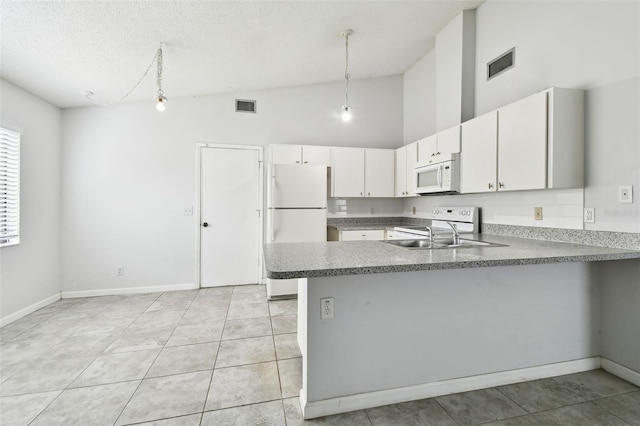 12315 Hidden Brook Dr, Tampa, FL 33624 - kitchen featuring white appliances, a peninsula, high vaulted ceiling, a textured ceiling, and white cabinetry
