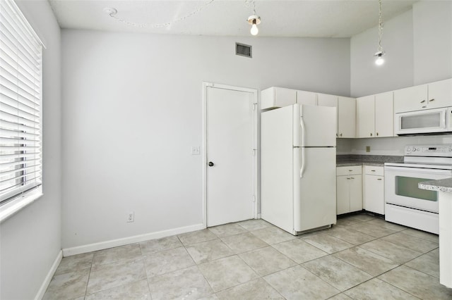 12315 Hidden Brook Dr, Tampa, FL 33624 - kitchen featuring white appliances, healthy amount of natural light, high vaulted ceiling, light tile patterned floors, and pendant lighting