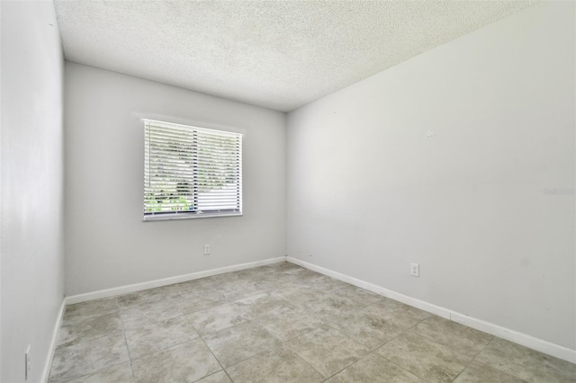 12315 Hidden Brook Dr, Tampa, FL 33624 - spare room with a textured ceiling and light tile patterned floors
