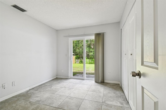 12315 Hidden Brook Dr, Tampa, FL 33624 - unfurnished room featuring a textured ceiling and light tile patterned floors