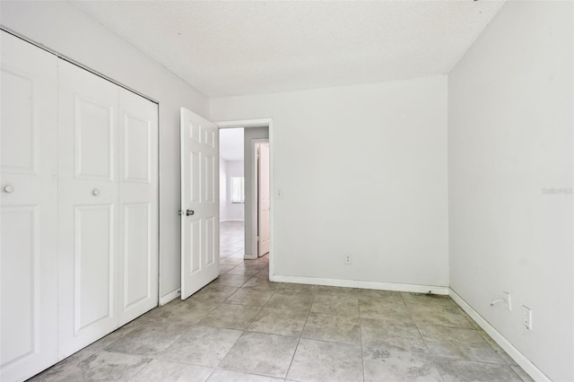 12315 Hidden Brook Dr, Tampa, FL 33624 - unfurnished bedroom featuring a textured ceiling and a closet