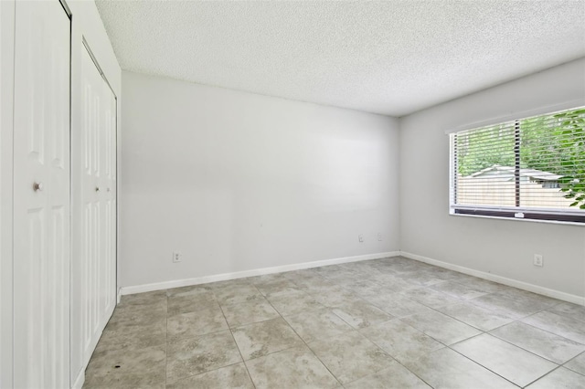12315 Hidden Brook Dr, Tampa, FL 33624 - unfurnished bedroom featuring a closet and a textured ceiling