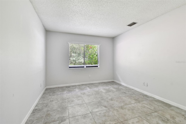 12315 Hidden Brook Dr, Tampa, FL 33624 - empty room with a textured ceiling and light tile patterned flooring