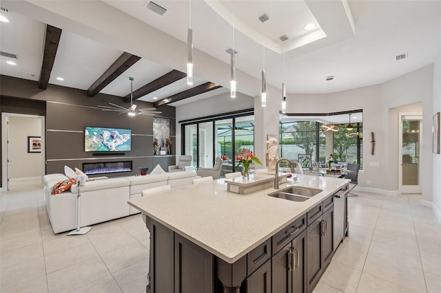 1042 Tuscany Dr, Trinity, FL 34655 - kitchen featuring a ceiling fan, light tile patterned floors, a center island with sink, hanging light fixtures, and recessed lighting