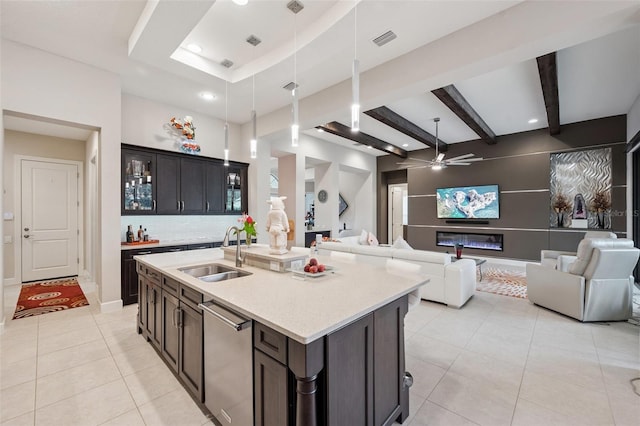 1042 Tuscany Dr, Trinity, FL 34655 - kitchen featuring light tile patterned floors, dishwasher, ceiling fan, open floor plan, and an island with sink