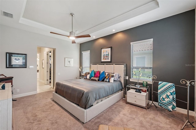 1042 Tuscany Dr, Trinity, FL 34655 - carpeted bedroom featuring a tray ceiling, recessed lighting, a ceiling fan, and ensuite bathroom