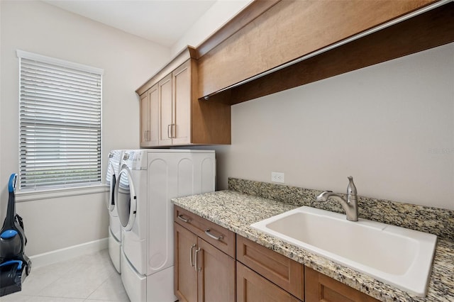 1042 Tuscany Dr, Trinity, FL 34655 - laundry area with washer and clothes dryer, cabinet space, and light tile patterned flooring