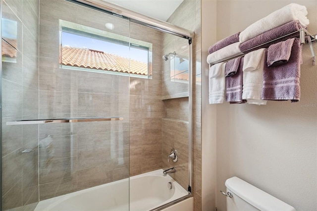 1042 Tuscany Dr, Trinity, FL 34655 - full bathroom featuring toilet and bath / shower combo with glass door
