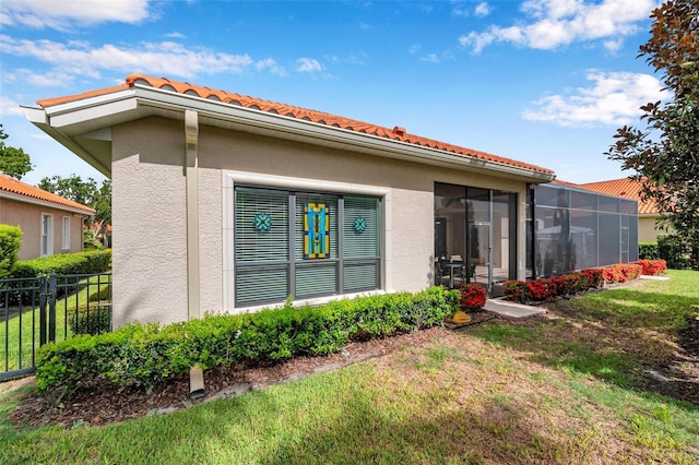 1042 Tuscany Dr, Trinity, FL 34655 - rear view of property featuring a tiled roof and stucco siding