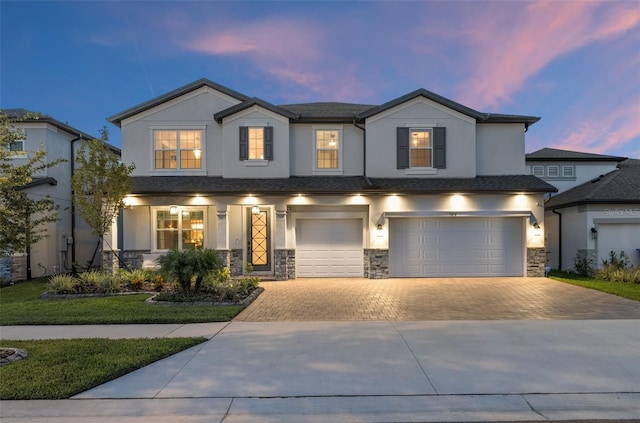 7819 Notched Pine Bnd, Wesley Chapel, FL 33545 - view of front of property featuring a garage, driveway, stucco siding, and stone siding
