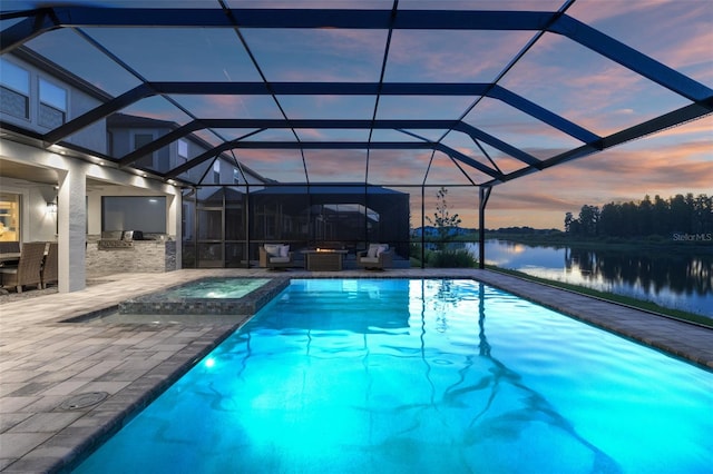 7819 Notched Pine Bnd, Wesley Chapel, FL 33545 - view of swimming pool with a water view, a patio area, an outdoor kitchen, a pool with connected hot tub, and glass enclosure