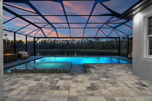 7819 Notched Pine Bnd, Wesley Chapel, FL 33545 - pool at dusk featuring a patio, a lanai, and a pool with connected hot tub