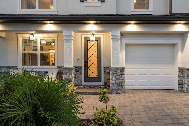 7819 Notched Pine Bnd, Wesley Chapel, FL 33545 - entrance to property featuring stucco siding, stone siding, and a garage