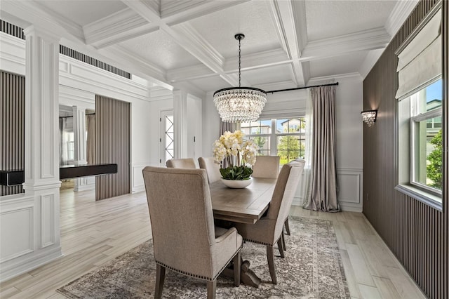 7819 Notched Pine Bnd, Wesley Chapel, FL 33545 - dining space with beamed ceiling, coffered ceiling, a chandelier, crown molding, and light wood-style floors