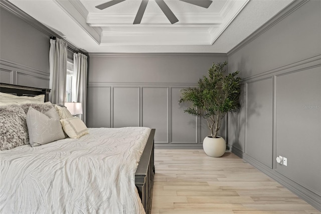 7819 Notched Pine Bnd, Wesley Chapel, FL 33545 - bedroom featuring a decorative wall, ornamental molding, light wood finished floors, a raised ceiling, and a ceiling fan