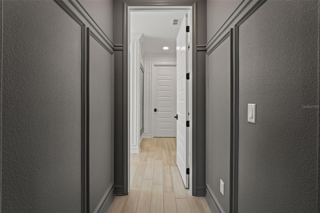 7819 Notched Pine Bnd, Wesley Chapel, FL 33545 - hall featuring light wood-style floors and a textured wall