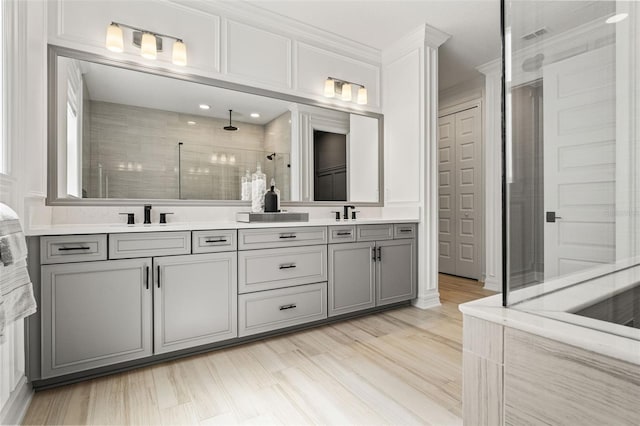 7819 Notched Pine Bnd, Wesley Chapel, FL 33545 - full bath featuring tiled shower, double vanity, ornamental molding, and wood finished floors