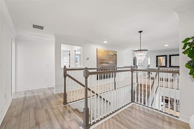 7819 Notched Pine Bnd, Wesley Chapel, FL 33545 - hallway featuring an upstairs landing, crown molding, wood finished floors, a chandelier, and recessed lighting