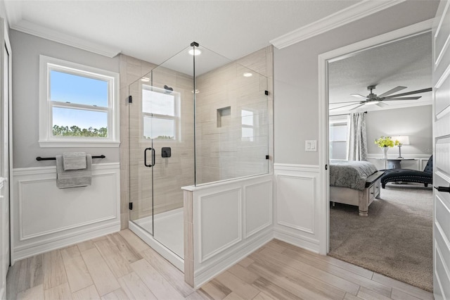 7819 Notched Pine Bnd, Wesley Chapel, FL 33545 - full bathroom featuring a decorative wall, connected bathroom, a shower stall, a ceiling fan, and a wainscoted wall