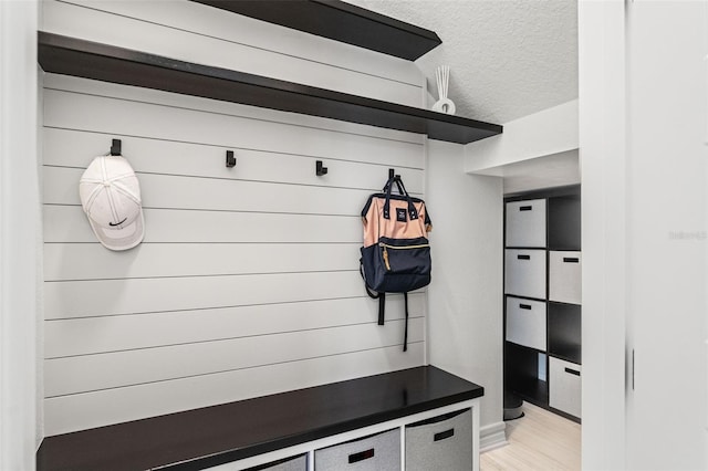 7819 Notched Pine Bnd, Wesley Chapel, FL 33545 - mudroom featuring a textured ceiling and light wood finished floors