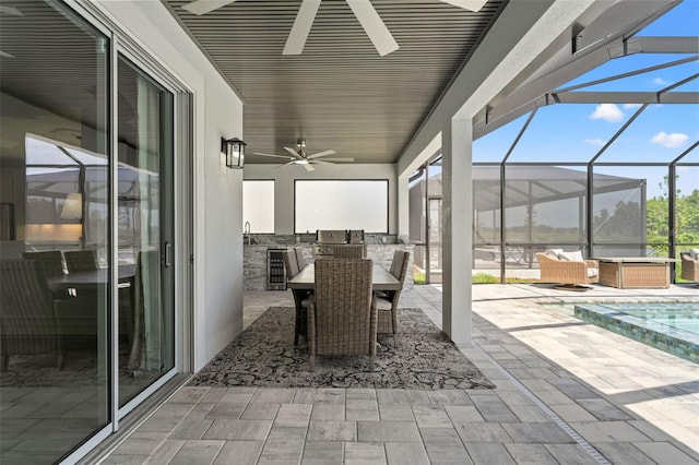 7819 Notched Pine Bnd, Wesley Chapel, FL 33545 - view of patio / terrace with exterior kitchen, ceiling fan, outdoor dining area, an outdoor pool, and a lanai