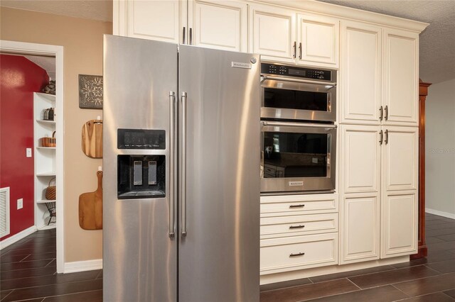 1132 Gershwin Dr, Largo, FL 33771 - kitchen with appliances with stainless steel finishes, wood finish floors, and cream cabinetry