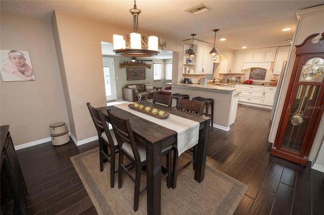 1132 Gershwin Dr, Largo, FL 33771 - dining area with dark wood-style flooring, a chandelier, and recessed lighting