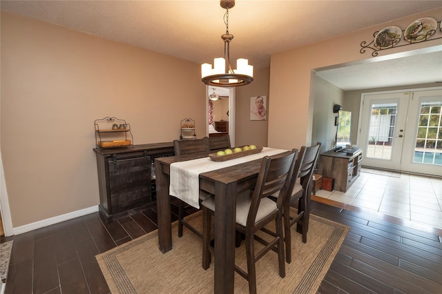1132 Gershwin Dr, Largo, FL 33771 - dining area featuring dark wood finished floors, a chandelier, and french doors
