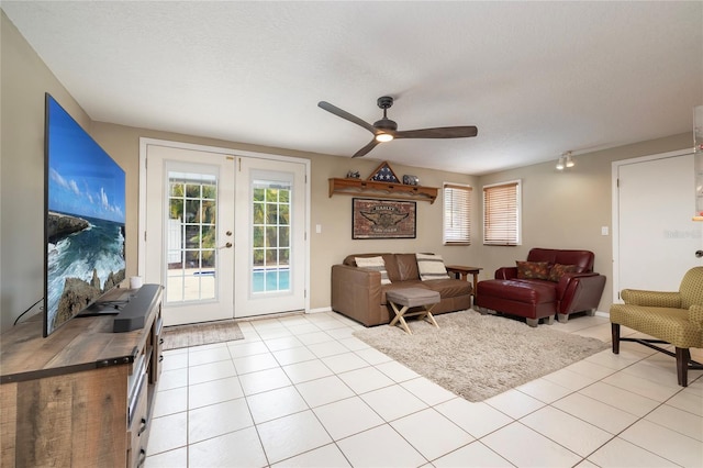 1132 Gershwin Dr, Largo, FL 33771 - living room featuring french doors, ceiling fan, light tile patterned flooring, and a textured ceiling
