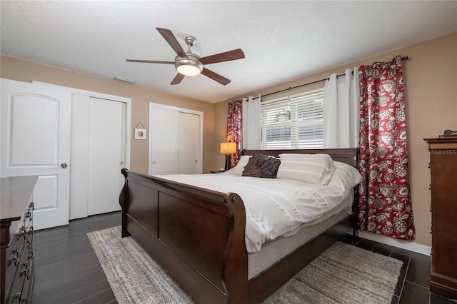 1132 Gershwin Dr, Largo, FL 33771 - bedroom featuring ceiling fan, a textured ceiling, multiple closets, and dark wood-type flooring