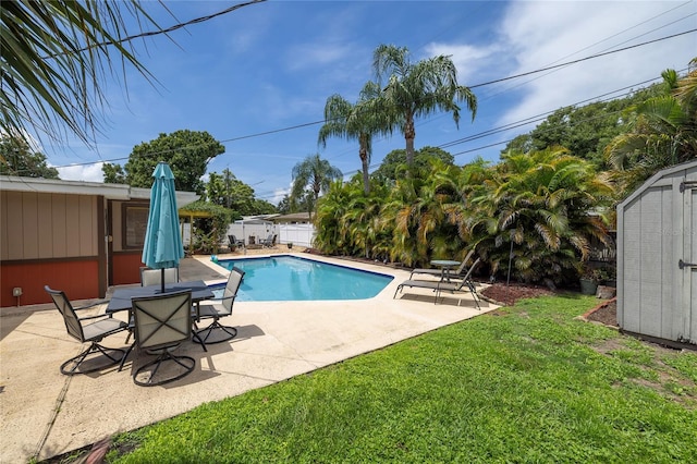 1132 Gershwin Dr, Largo, FL 33771 - view of swimming pool with a patio area, a fenced backyard, and a storage unit
