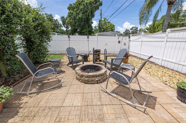 1132 Gershwin Dr, Largo, FL 33771 - fenced backyard with an outdoor fire pit and a patio