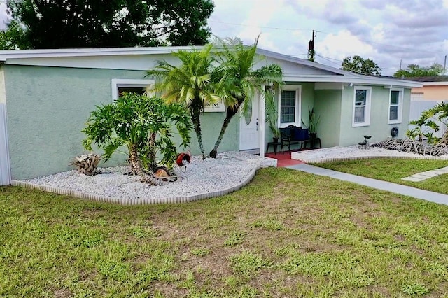 2813 W Kenmore Ave, Tampa, FL 33614 - view of front of house featuring stucco siding and a front lawn