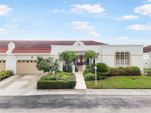 4719 61st Avenue Terrace W Unit 4719, Bradenton, FL 34210 - mediterranean / spanish house with concrete driveway, a tiled roof, a garage, and stucco siding