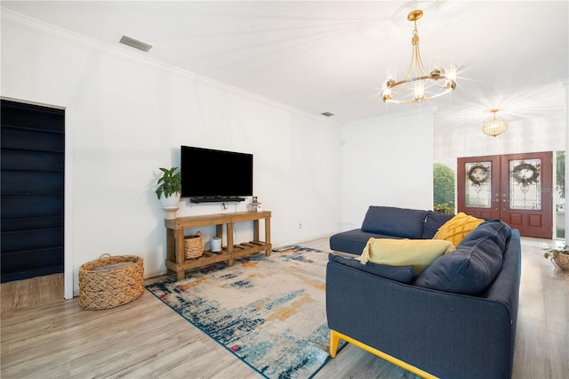 4719 61st Avenue Terrace W Unit 4719, Bradenton, FL 34210 - living room with a chandelier, wood finished floors, french doors, and crown molding