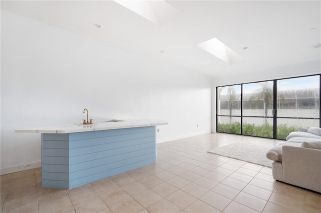 4719 61st Avenue Terrace W Unit 4719, Bradenton, FL 34210 - unfurnished living room featuring a skylight, lofted ceiling, and light tile patterned floors