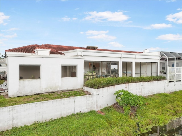 4719 61st Avenue Terrace W Unit 4719, Bradenton, FL 34210 - back of property featuring a tiled roof, stucco siding, and a sunroom