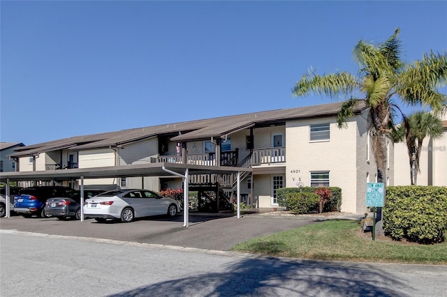 4901 Onyx Ln Unit 204, New Port Richey, FL 34652 - view of building exterior with covered parking and stairs
