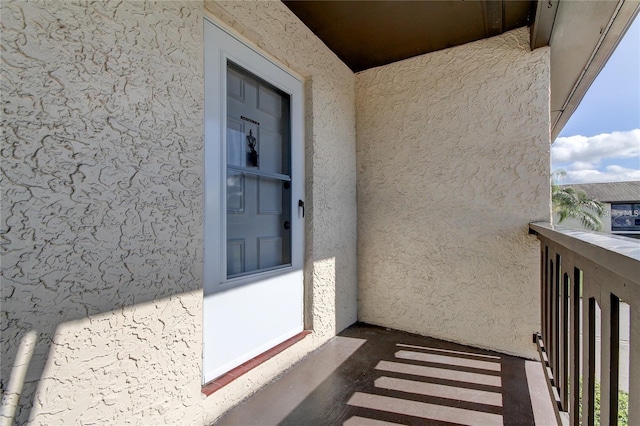 4901 Onyx Ln Unit 204, New Port Richey, FL 34652 - doorway to property featuring stucco siding and a balcony