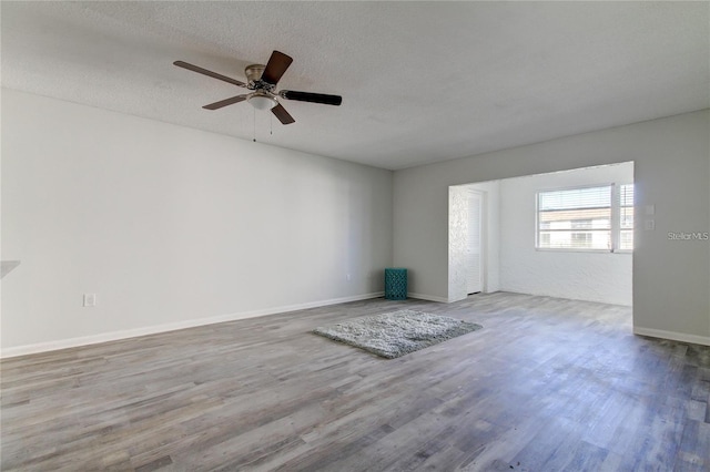 4901 Onyx Ln Unit 204, New Port Richey, FL 34652 - unfurnished room with wood finished floors, ceiling fan, and a textured ceiling