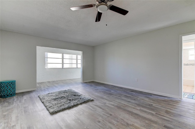 4901 Onyx Ln Unit 204, New Port Richey, FL 34652 - spare room with wood finished floors, a ceiling fan, and a textured ceiling