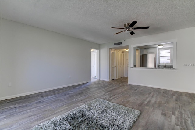 4901 Onyx Ln Unit 204, New Port Richey, FL 34652 - unfurnished living room featuring wood finished floors, ceiling fan, and a textured ceiling