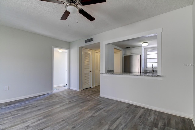 4901 Onyx Ln Unit 204, New Port Richey, FL 34652 - spare room featuring wood finished floors, a ceiling fan, and a textured ceiling